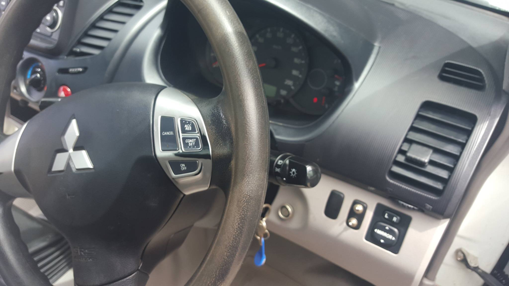 The steering wheel and dashboard of a Mitsubishi car — Country Dirt Blasters Mobile Car Detailing In Murwillumbah, NSW