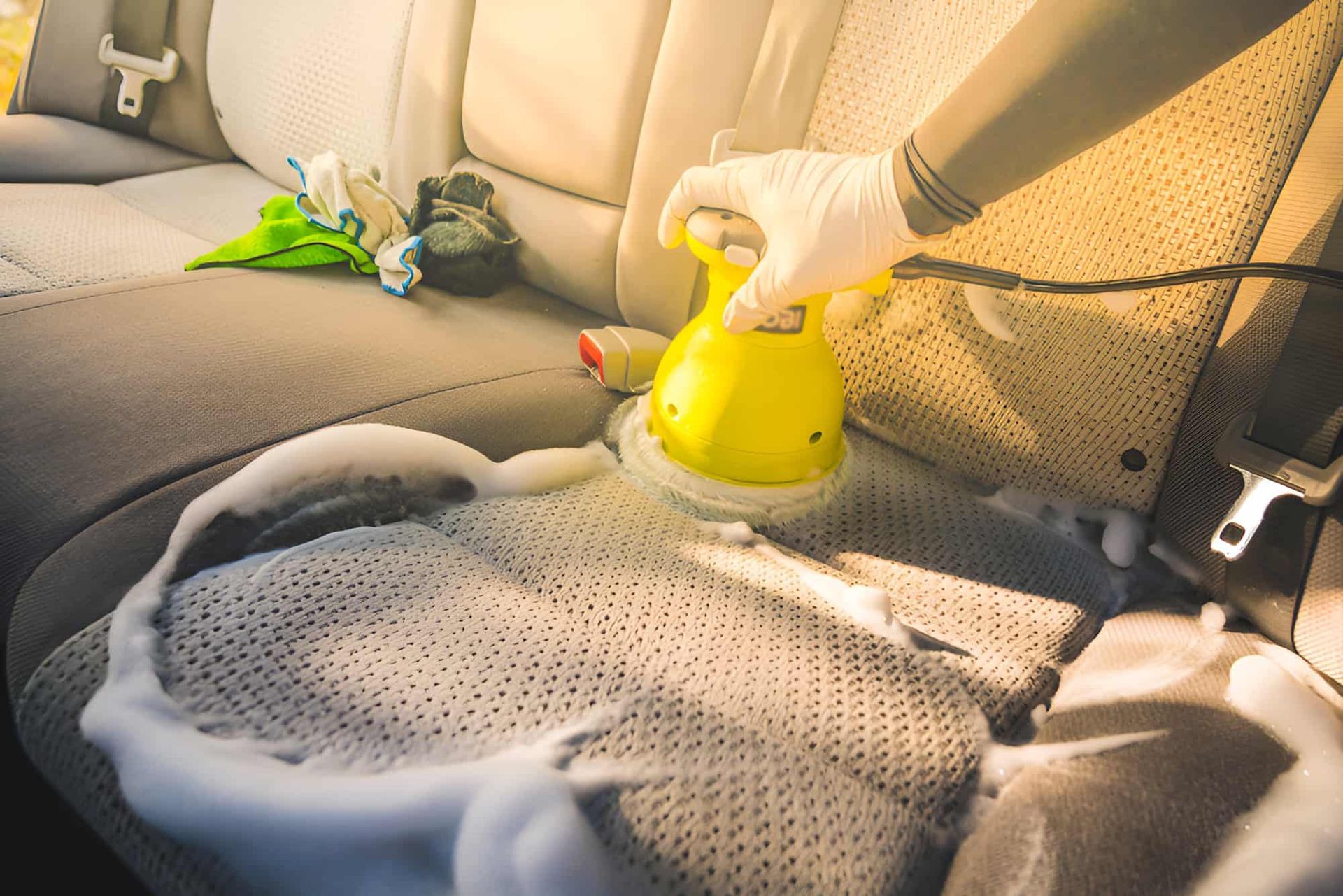 A Person Is Cleaning The Seats Of A Car With A Machine — Country Dirt Blasters Mobile Car Detailing In Murwillumbah, NSW