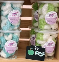 A display of apple rings with a sign that says $ 8 rings.
