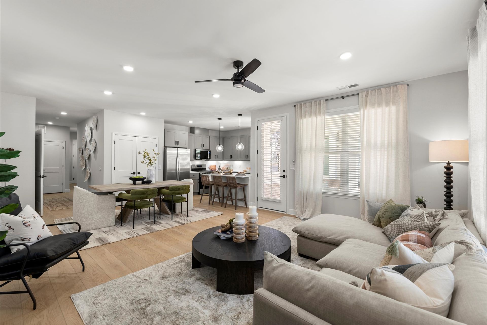 A living room filled with furniture and a ceiling fan.