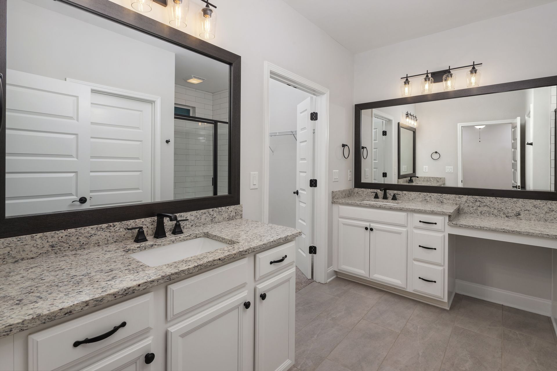 A bathroom with two sinks and two mirrors.