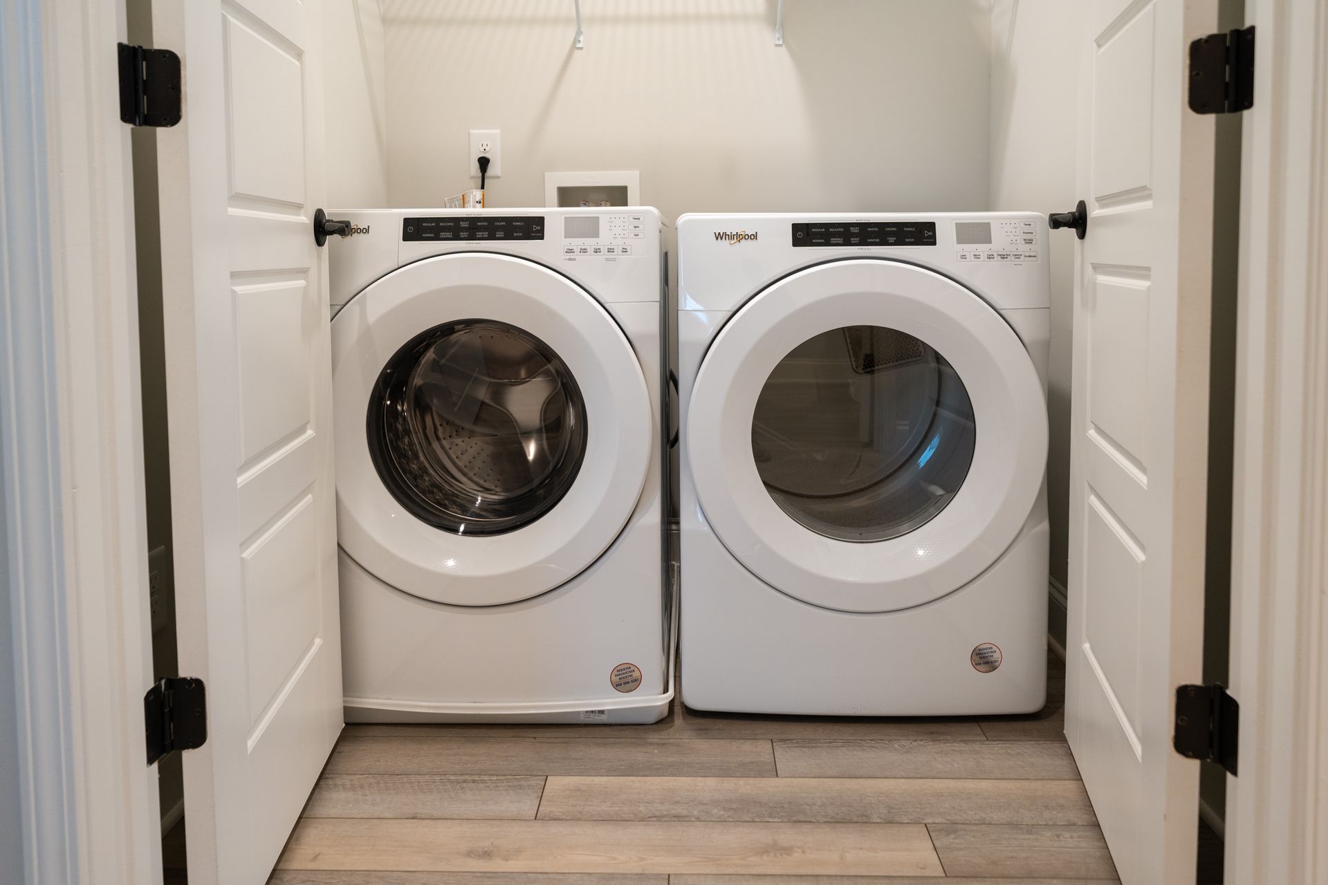 A washer and dryer are sitting next to each other in a laundry room.