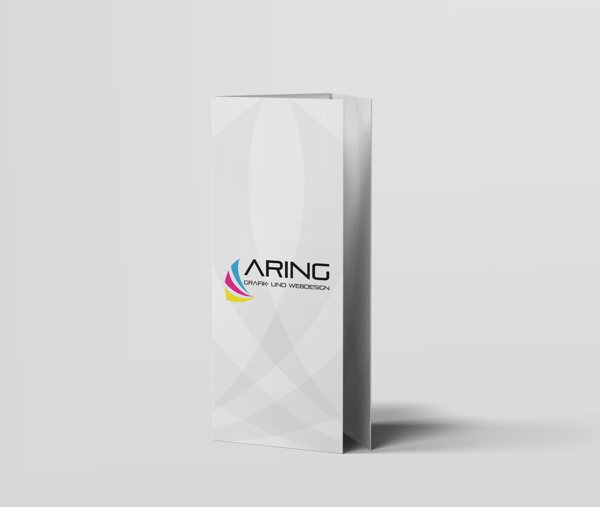 Auf einem Tisch liegt eine weiße Broschüre mit dem Wort „Aring“ darauf.