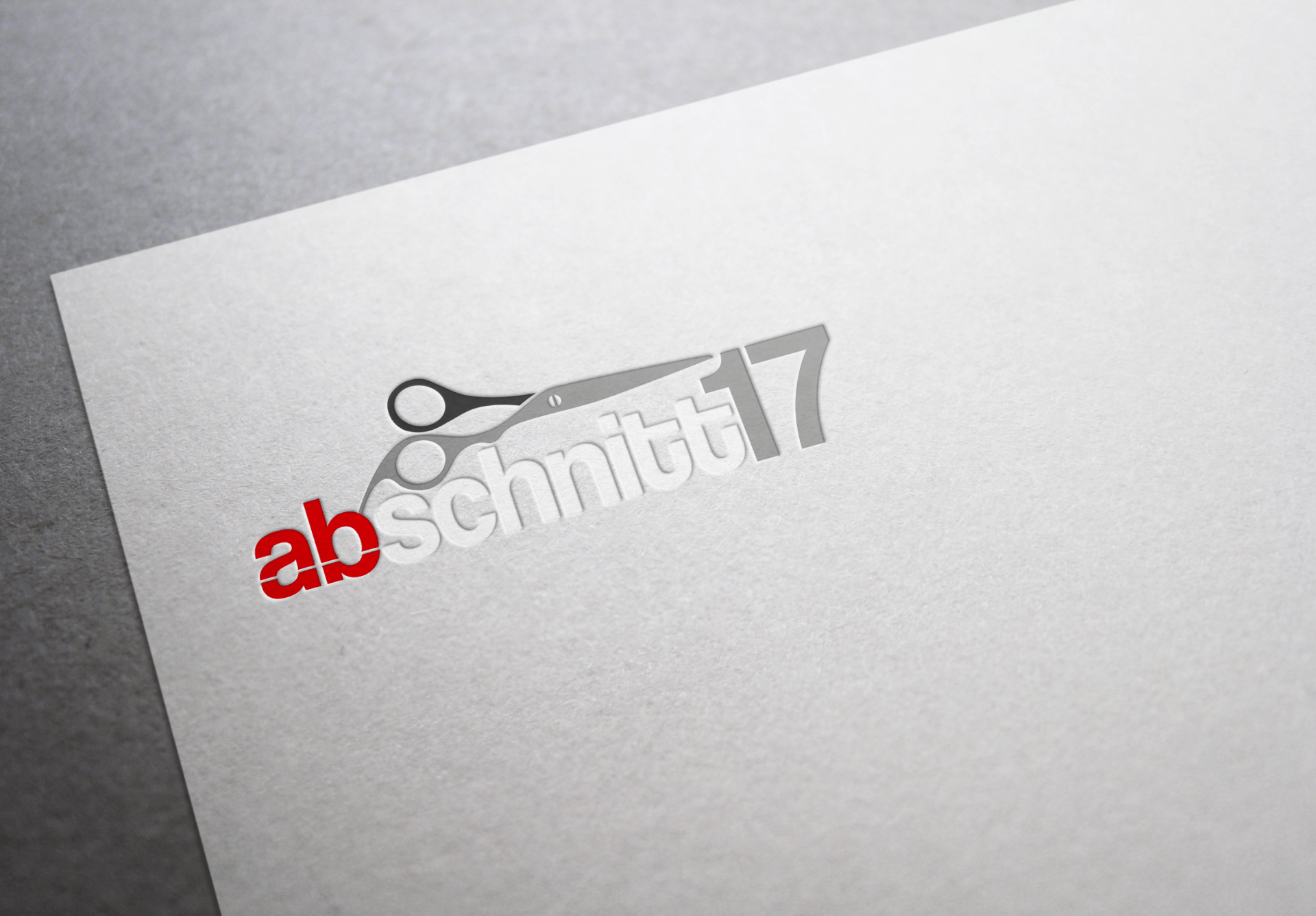 Ein weißes Blatt Papier mit einem Scherenlogo darauf