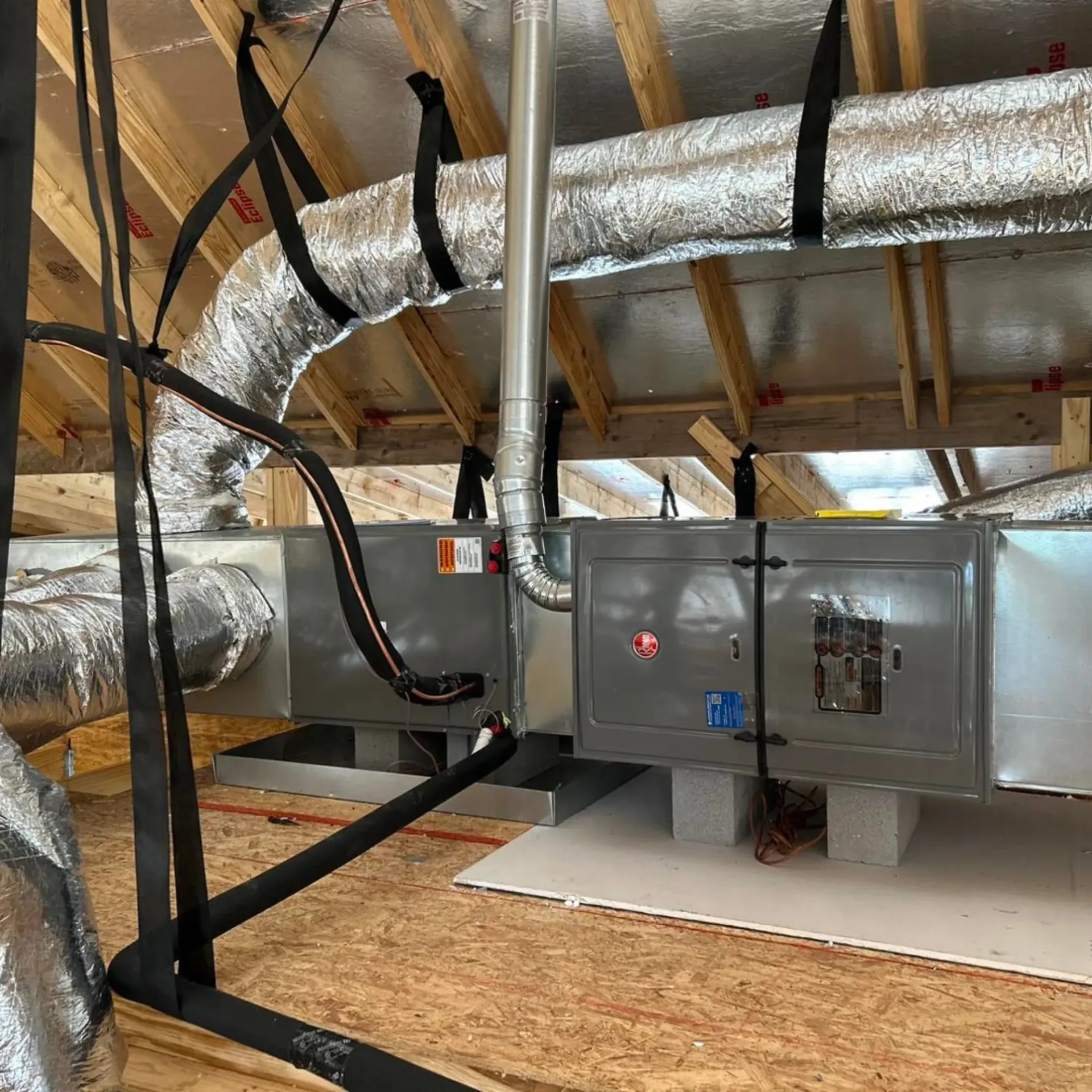 Flawless Heating and Air LLC - A room with a lot of pipes hanging from the ceiling.