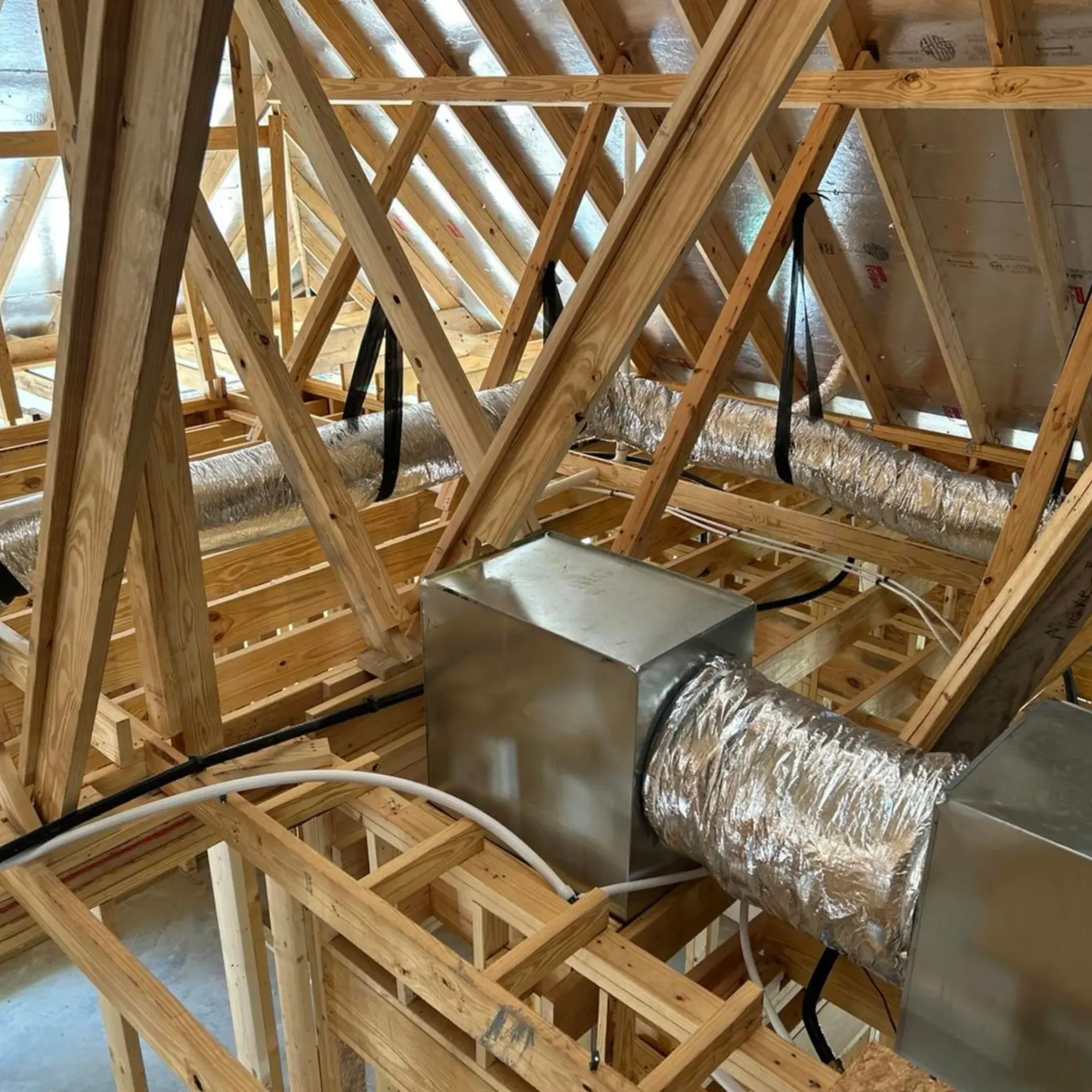 Flawless Heating and Air LLC - A building under construction with a lot of wooden beams and pipes.