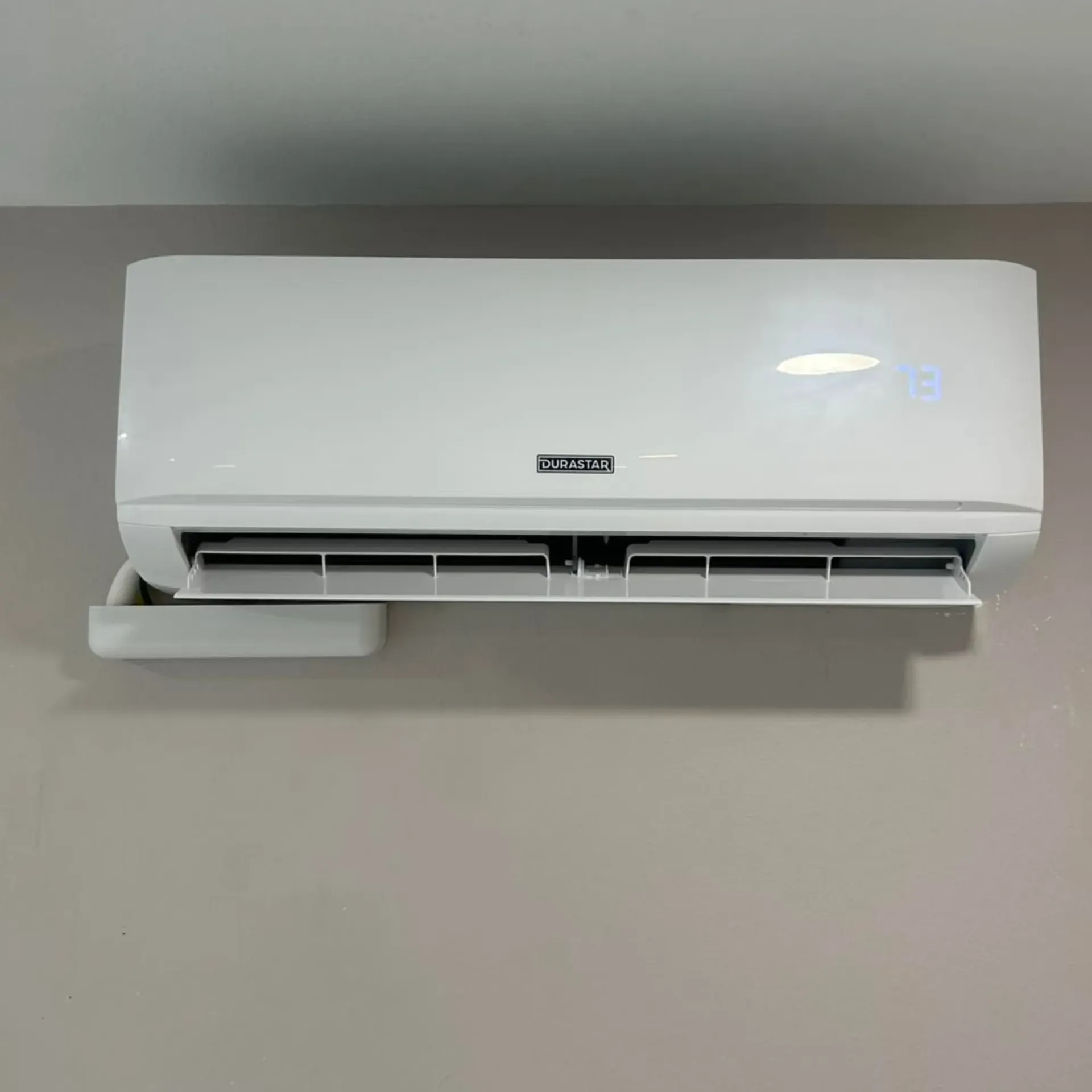 Flawless Heating and Air LLC - A white air conditioner is hanging on a wall.