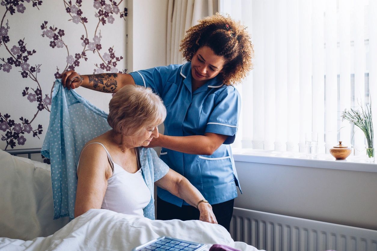 photo of caregiver assisting an elderly patient