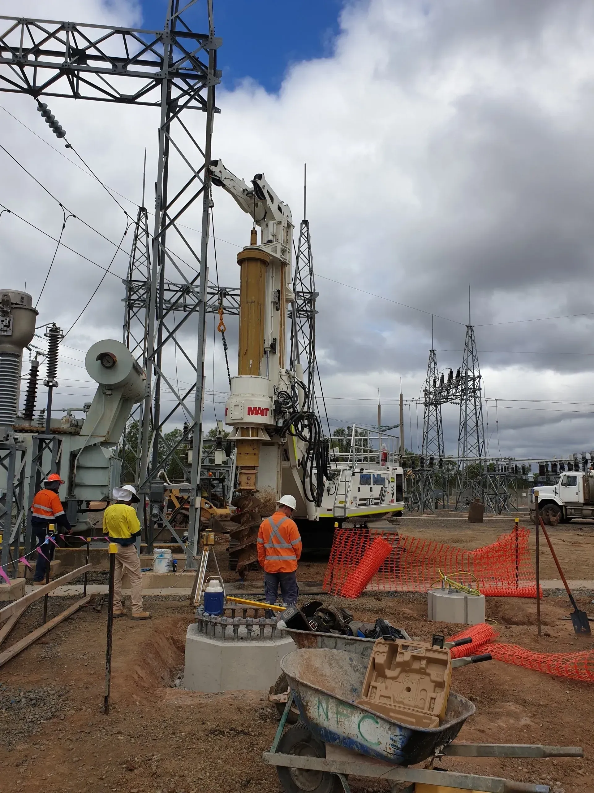 A group of construction workers are working on a power tower.