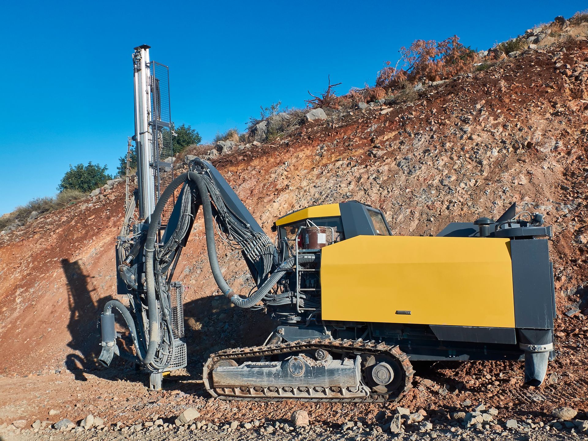 Yellow drilling rig is drilling holes during blasthole drilling operations. | Sunshine Coast, QLD 
