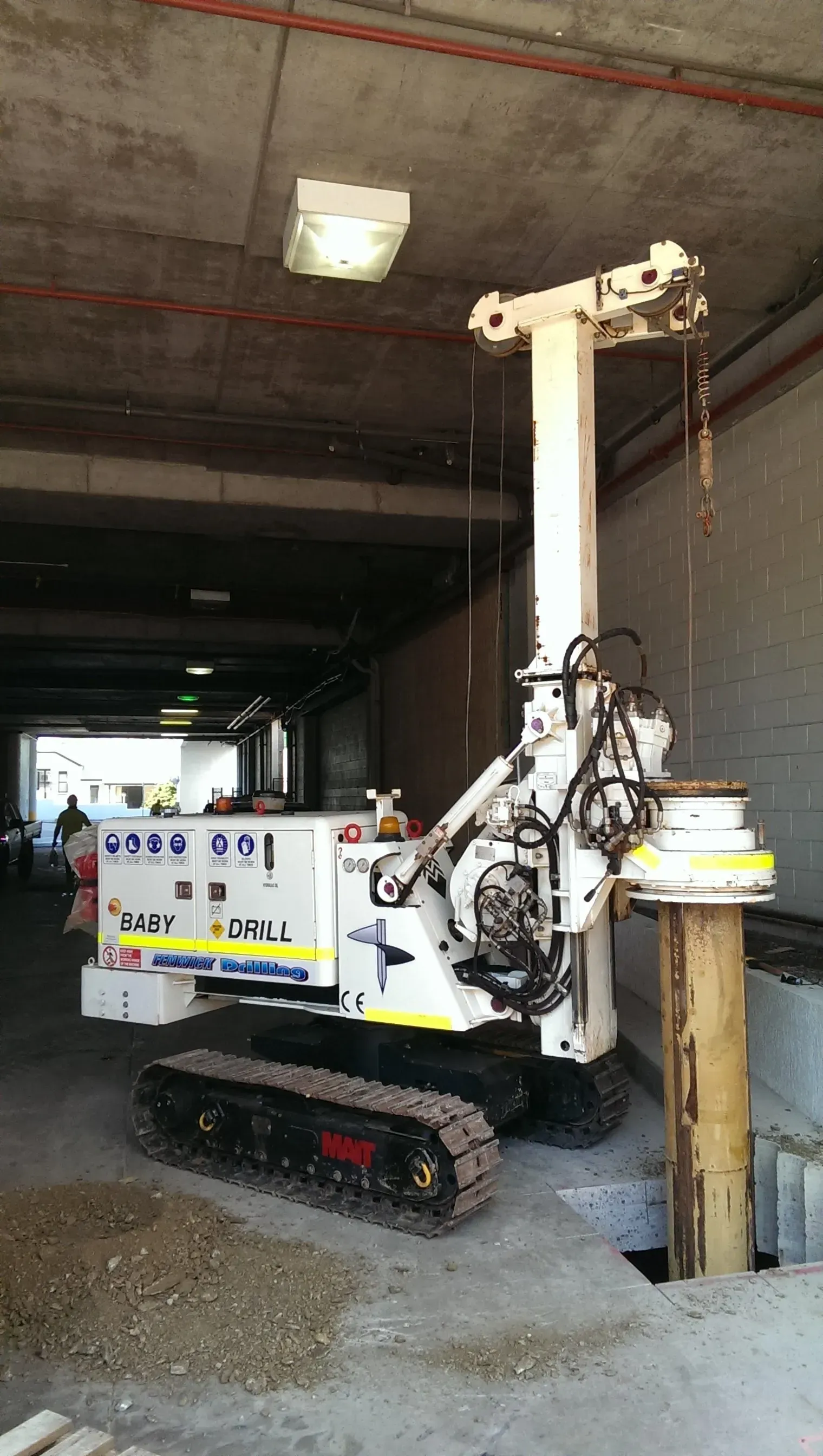 A machine is sitting on top of a pole in a building.