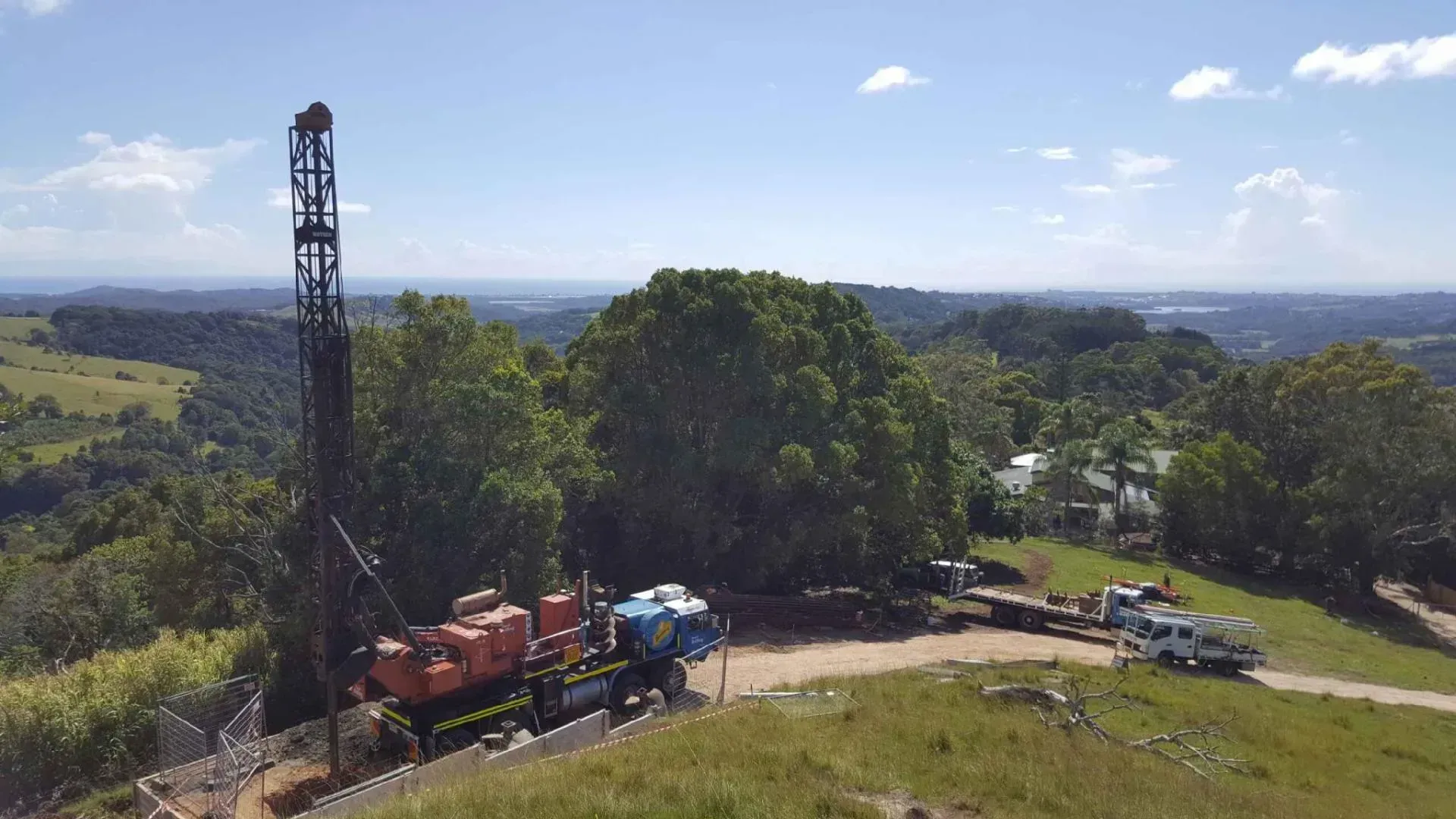 An aerial view of a drilling rig on top of a hill.