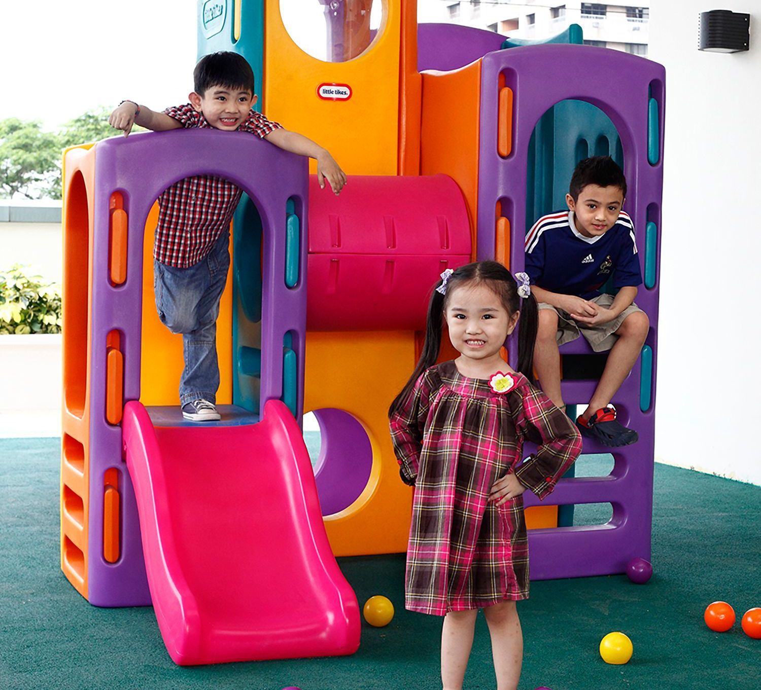 Three children playing at the children's play area at The Exchange Regency Hotel in Pasig