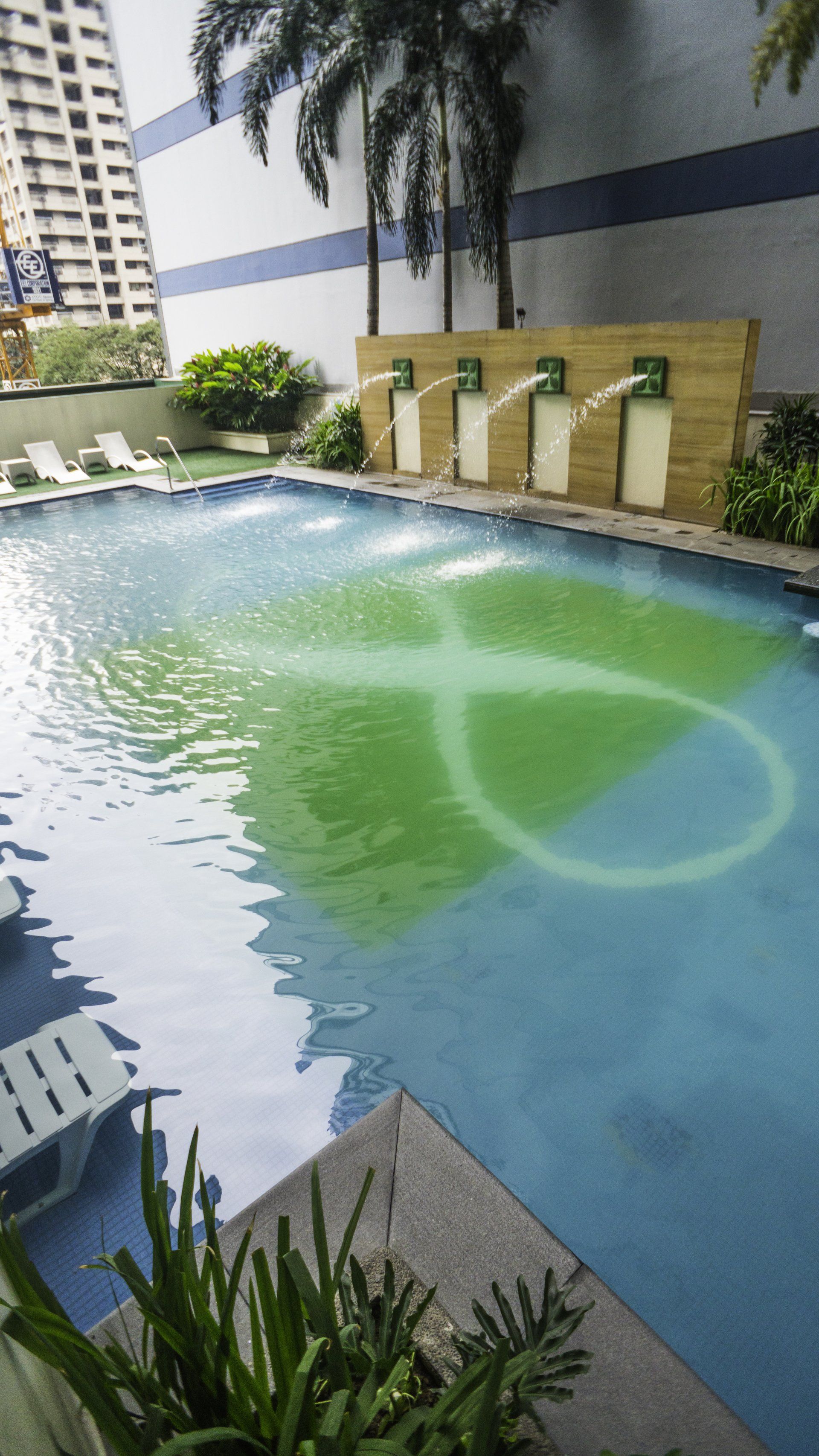 Outdoor pool with water features at The Exchange Regency Makati