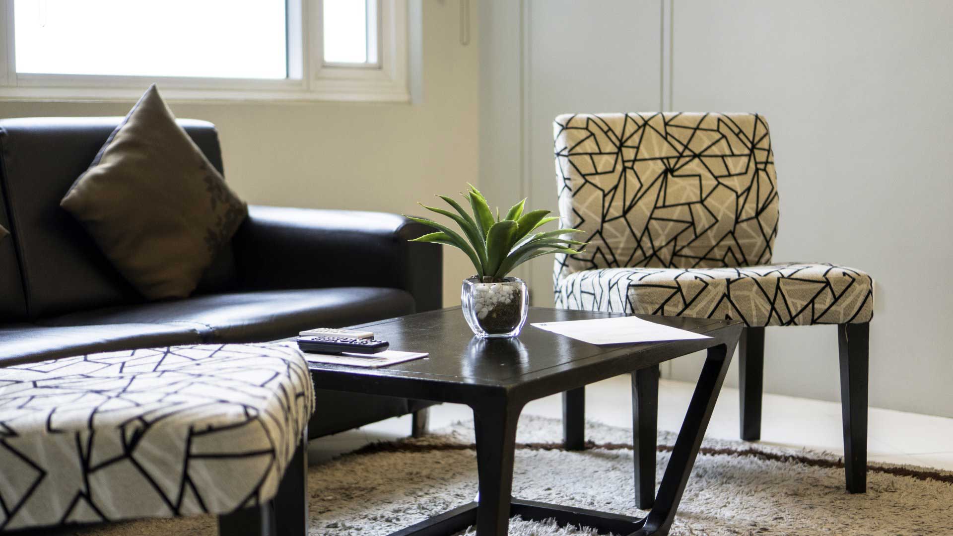 A living room with a couch, chairs, coffee table, perfect your Pasig staycation