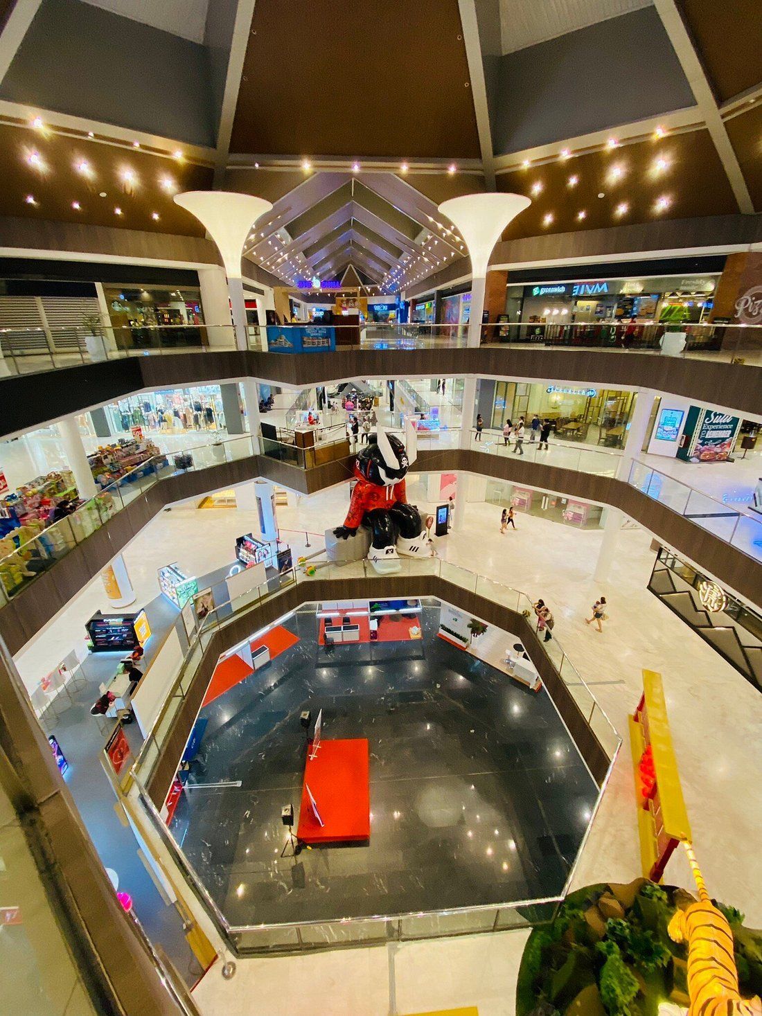An aerial view of a shopping mall filled with lots of shops and people.
