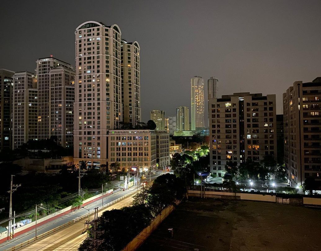 Hotel near SM Megamall city skyline at night with lit skyscrapers and streetlights