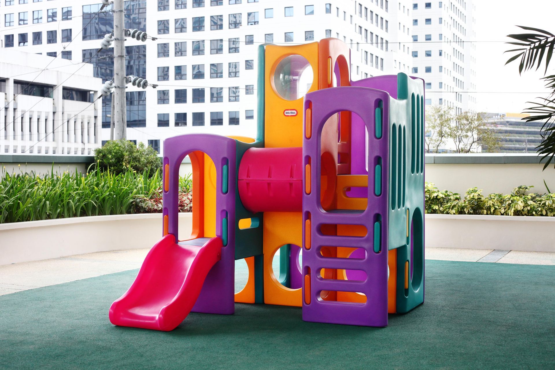 A colorful playground with a slide and tunnel