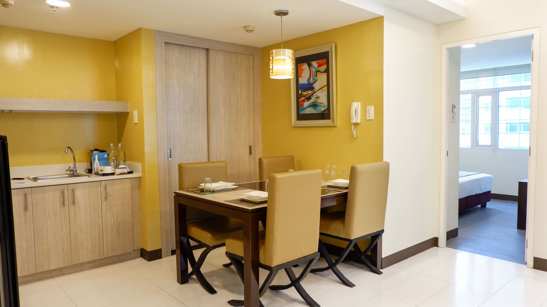 There is a dining table and chairs in the middle of the room.