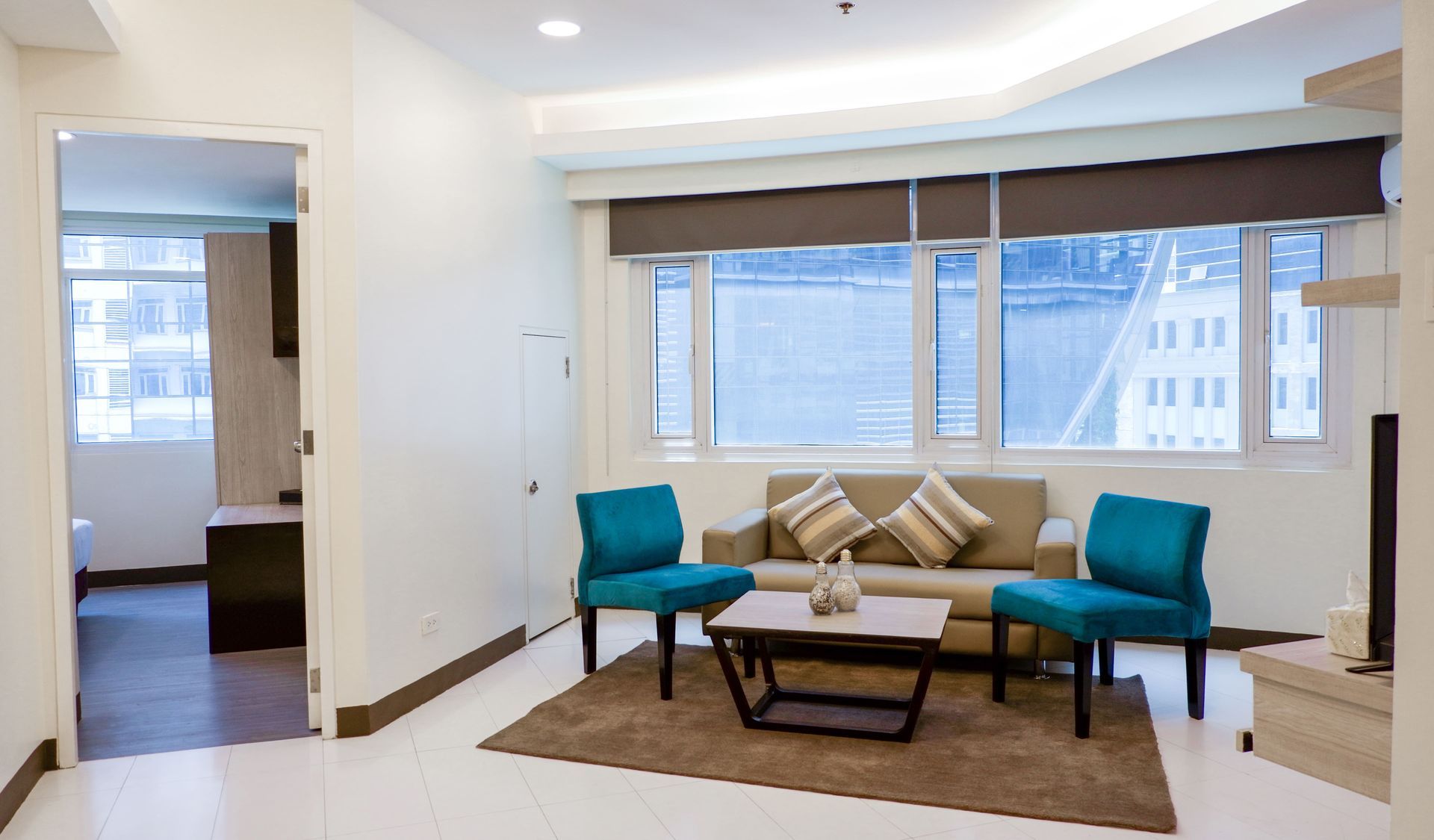 A living room with a couch , chairs , and a coffee table.