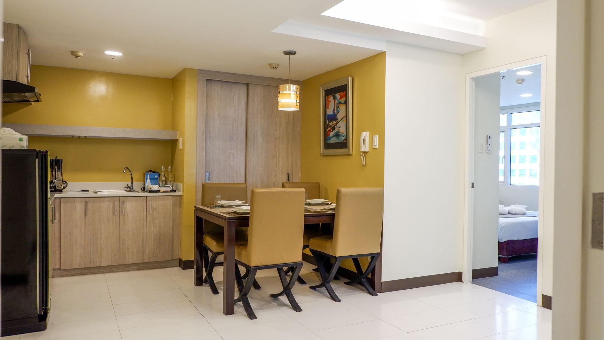 There is a dining table and chairs in the middle of the room.