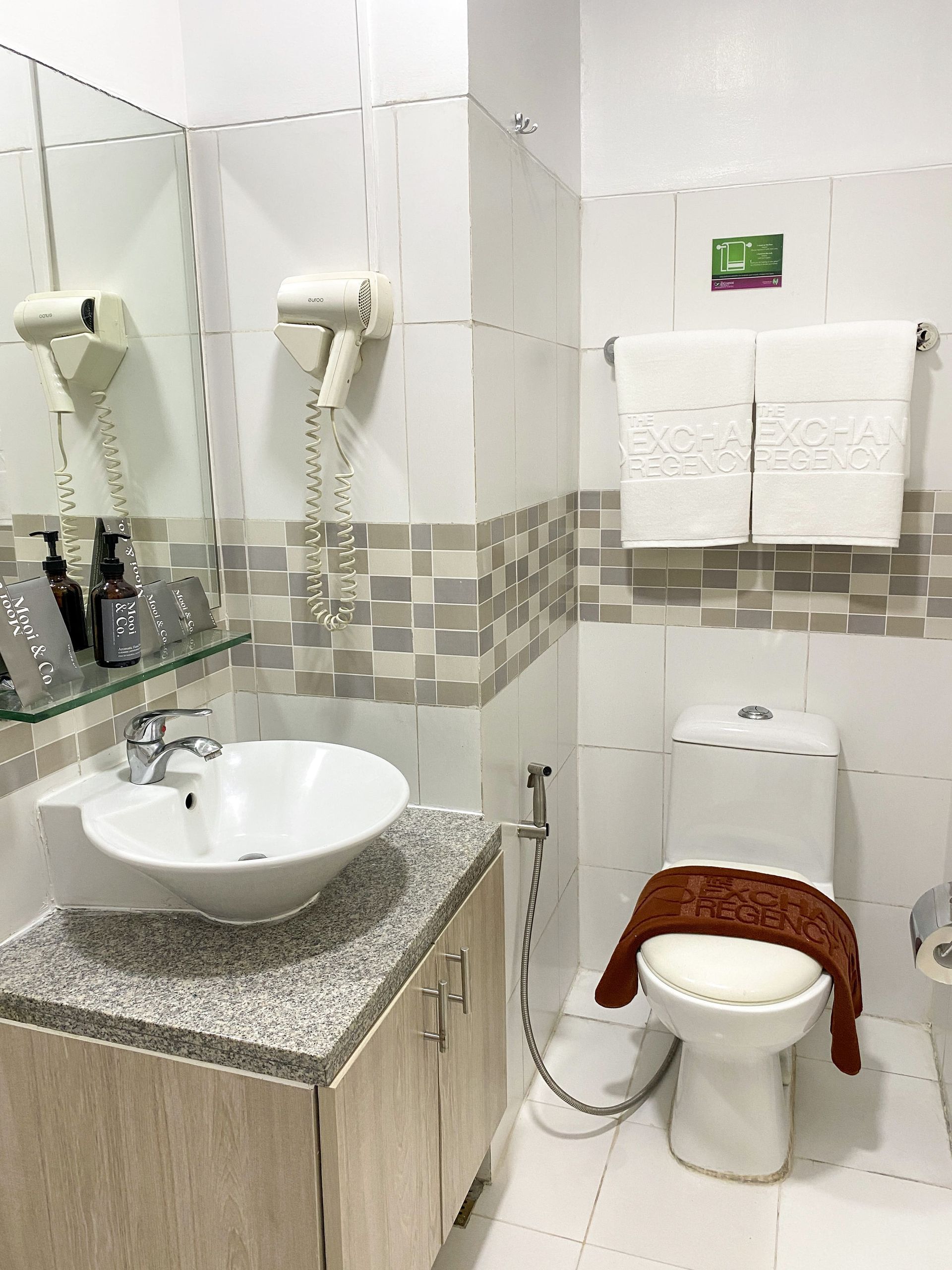 A bathroom with a sink , toilet and mirror