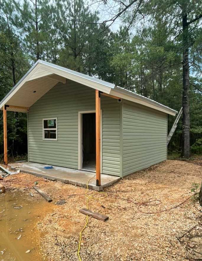 A small house is being built in the middle of a forest.