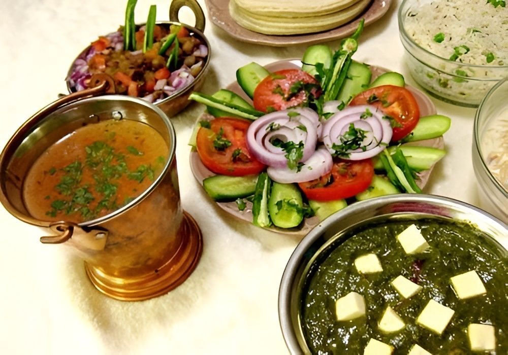 A Bowl Of Chicken Tikka Masala With Rice And Spices On A Wooden Table — Punjabi Sunrise Restaurant In Alexandra Hills, QLD