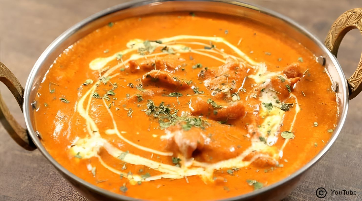 Close-Up of Butter Chicken in A Metal Bowl, Garnished with Cream and Parsley — Punjabi Sunrise Restaurant In Alexandra Hills, QLD