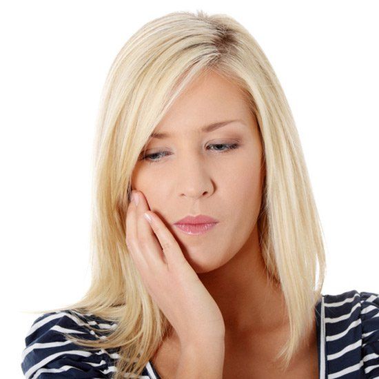 woman with tooth ache - teeth extractions