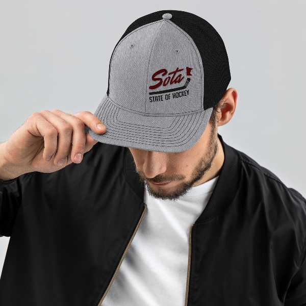 A man wearing a baseball cap with the word sota on it