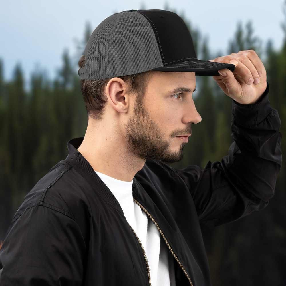 A man wearing a baseball cap and a black jacket
