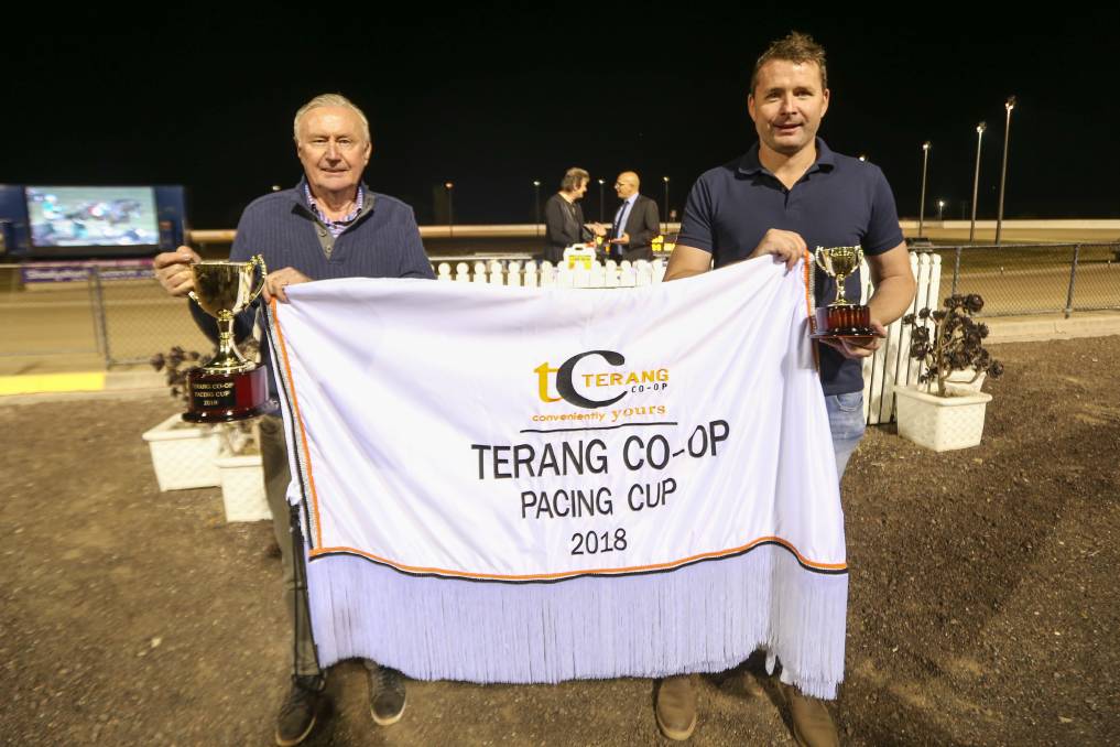 John and Adam Willkinson hold up the winning rug