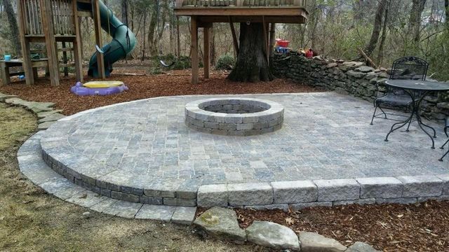 There is a fire pit in the middle of the patio.