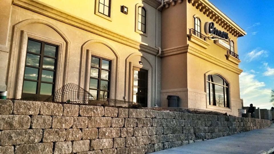 A large building with a brick wall in front of it