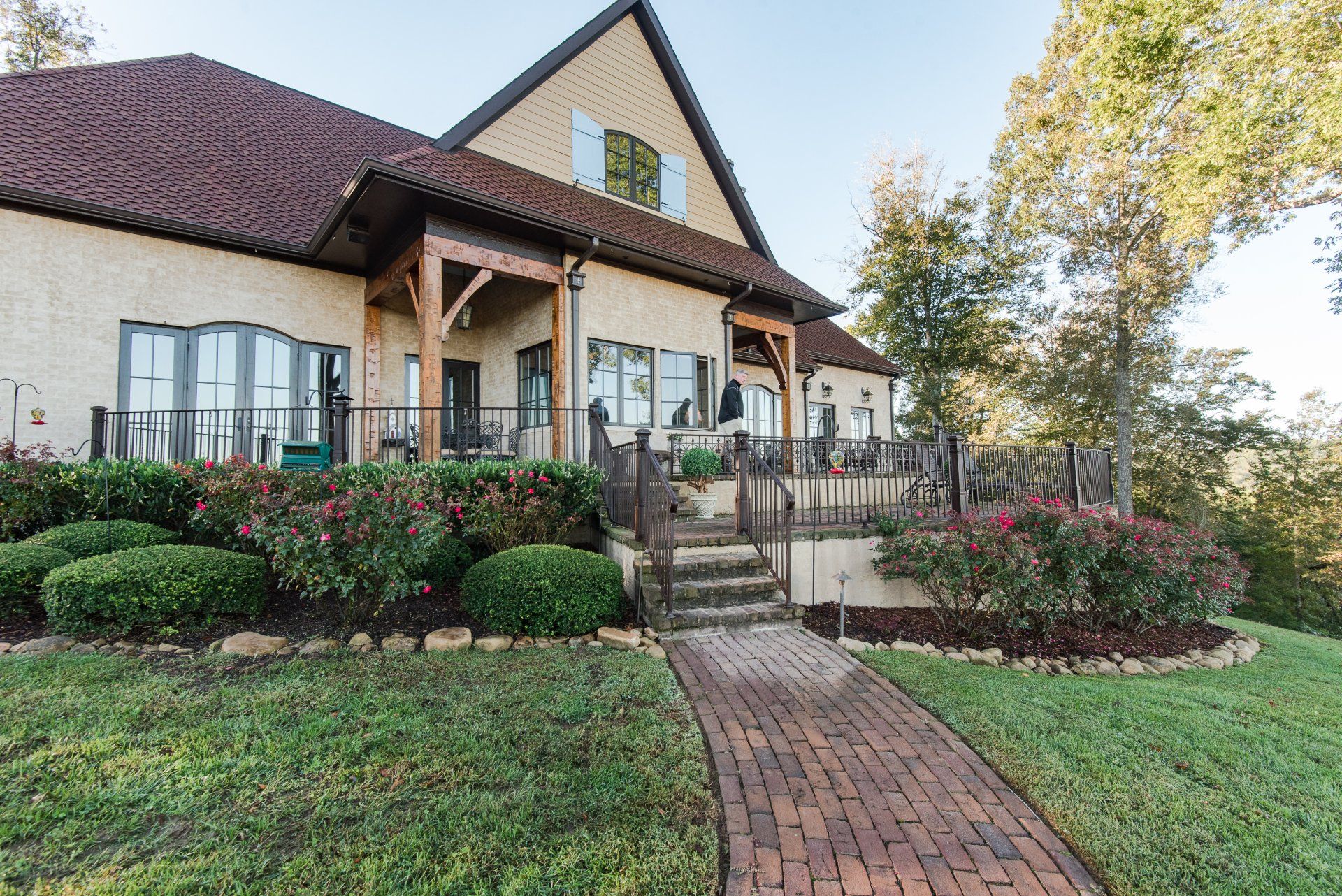 A large house with a brick walkway leading to it.