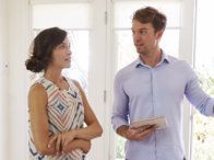 A man and a woman are standing next to each other in a room.