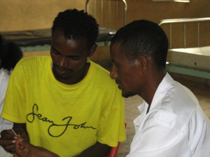 A man wearing a yellow shirt that says sean john