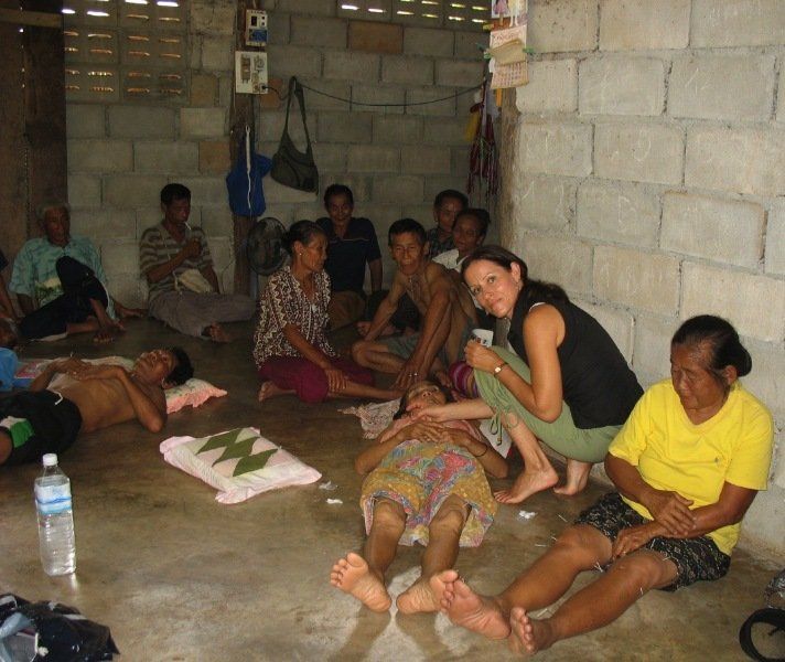 A group of people are sitting on the floor in a room
