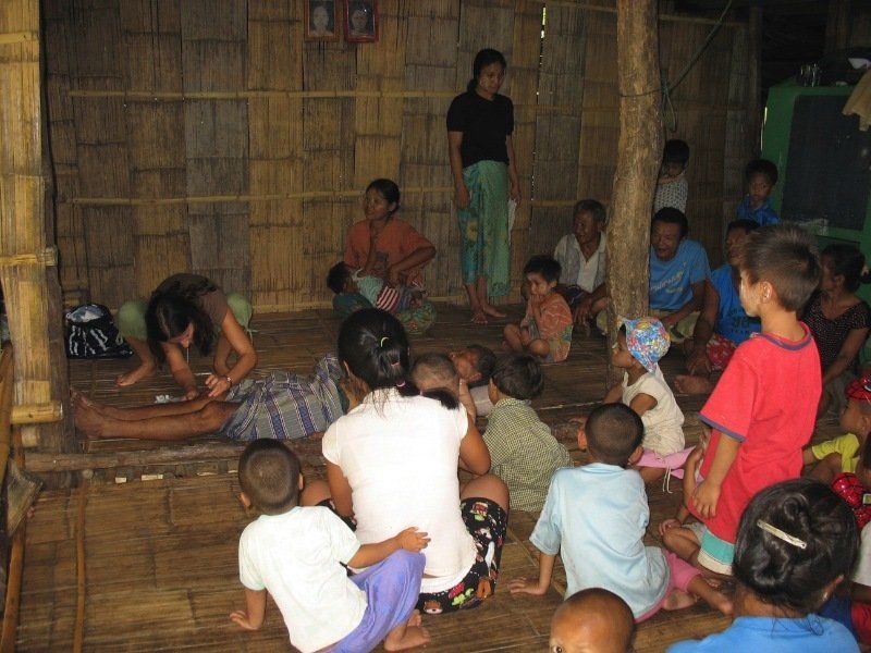 A group of people are sitting on the floor in a room.