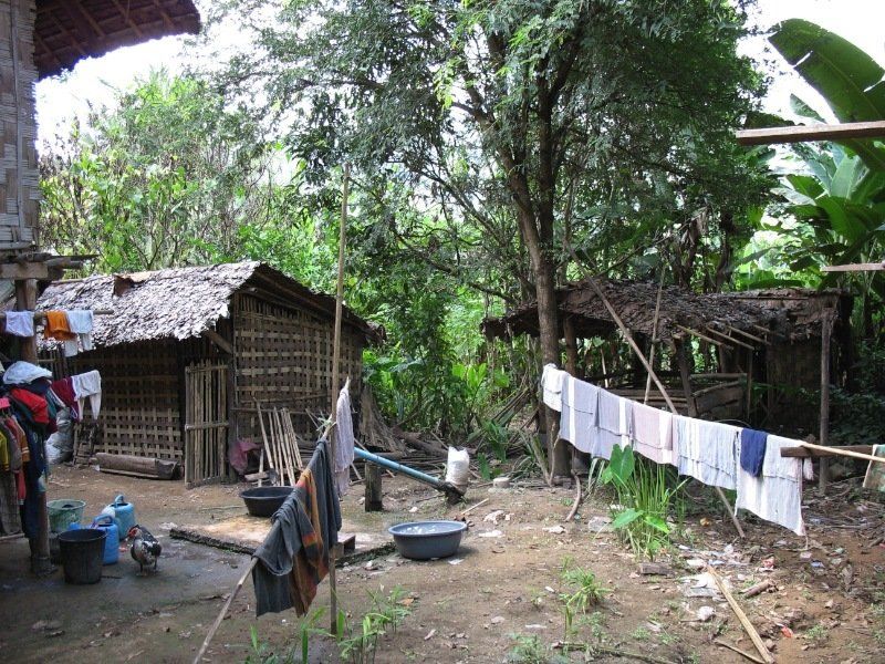 A bunch of clothes are hanging to dry in a yard