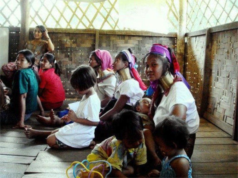 A group of people are sitting on the floor in a room