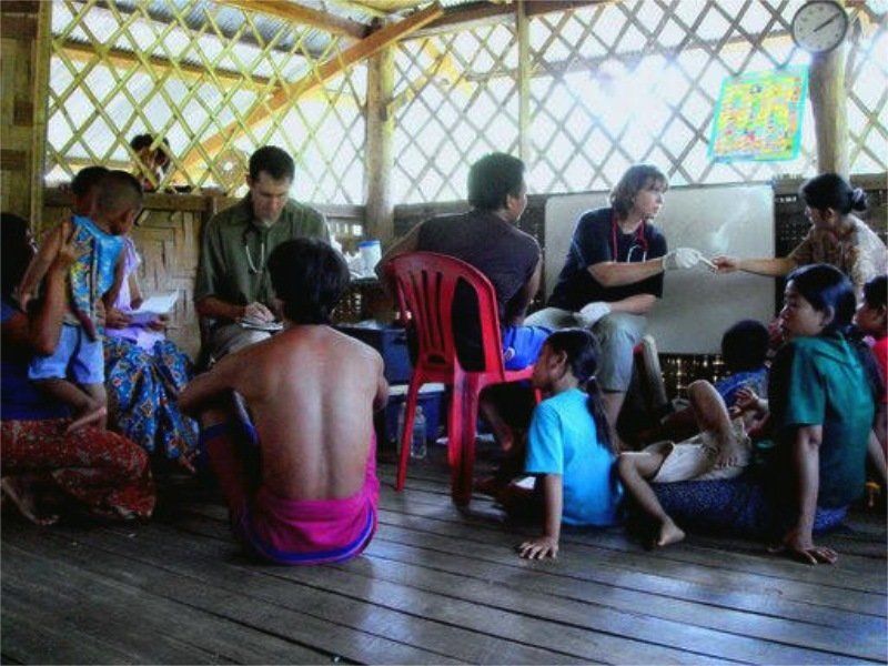 A group of people are sitting on the floor in a room
