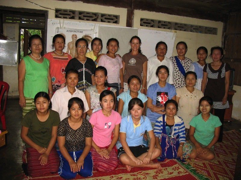 A group of women are posing for a picture in a room