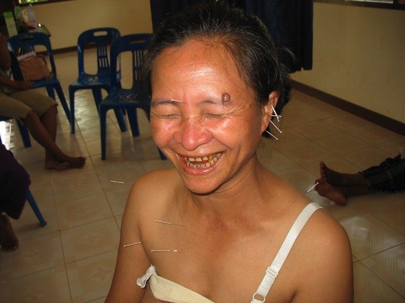 A woman with a letter d on her forehead is smiling