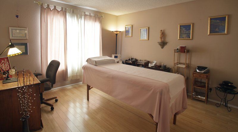 There is a massage table in the middle of the room.