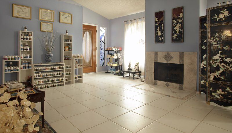 A living room with blue walls and white tile floors