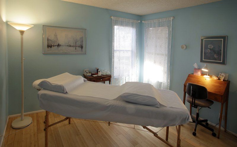 A massage table is sitting in a room with blue walls.