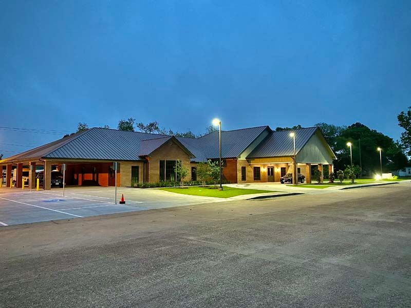Sunset over the ocean with colorful sky reflected on the wet sand.