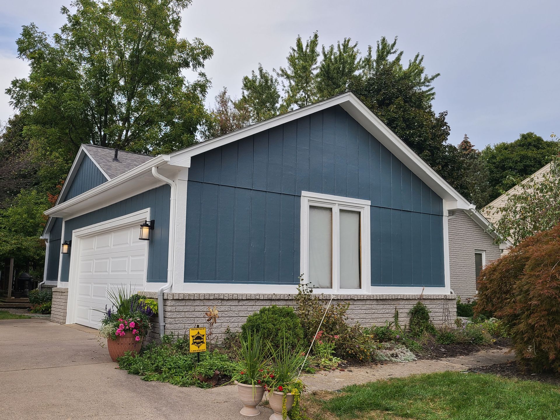 A blue and white house with a white garage door